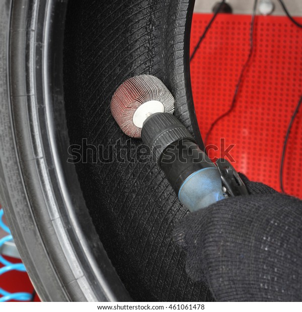 Car service: Tyre repair. The worker repair\
of tire - Vulcanization