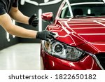 Car service worker applying nano coating on a car detail.