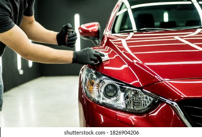 Car service worker applying nano coating on a car detail. - Shutterstock ID 1826904206