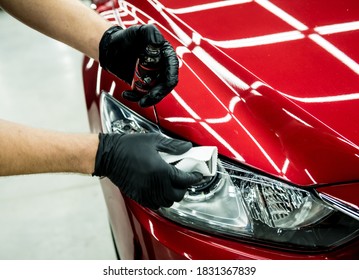 Car service worker applying nano coating on a car detail. - Shutterstock ID 1831367839
