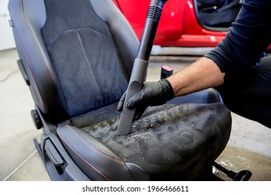 Car service worker cleaning car seat with vacuum cleaner. - Shutterstock ID 1966466611