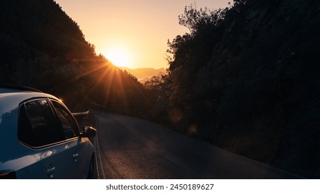 Car set back from the road with the sunset over the mountains - Powered by Shutterstock