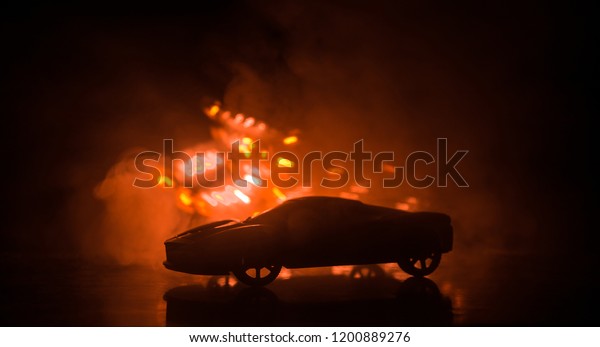 The car in
the shadows with glowing lights in low light, or silhouette of
sport car dark background. Selective
focus
