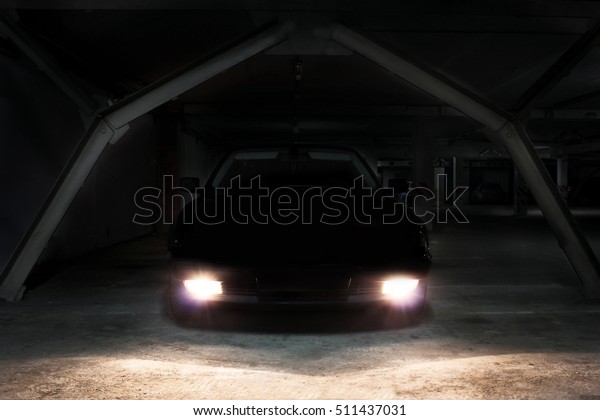 The car in the shadows with glowing lights in\
low light. Car. Supercar