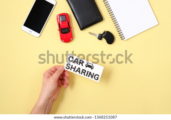 Car sharing concept. Human hand holding text sign\
\