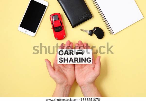 Car sharing concept. Human hands holding text sign\
\