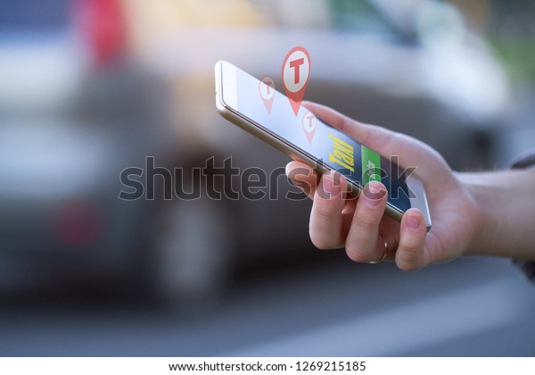 Car sharing and rent car\
concept. Customer calling a taxi through the mobile app. Rent a car\
online for short trips around the city. Sharing Economy. Taxi\
online