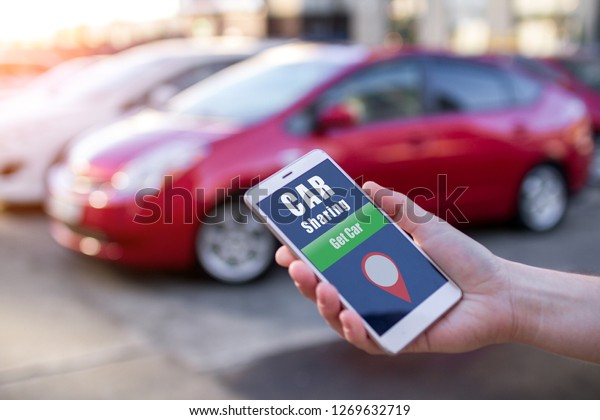 Car sharing and\
rental concept. Customer calling a taxi through the mobile app.\
Rent a car for short trips around the city. Sharing Economy. Taxi\
online and sharing concept
