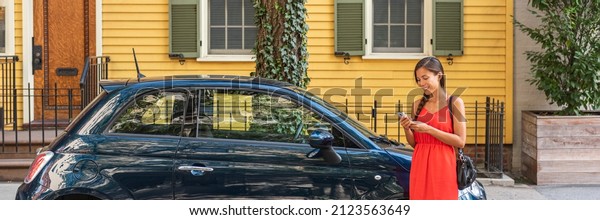 Car\
sharing rideshare phone app woman using technology mobile device\
online to sell used car or find parking in the city street at home.\
New car owner young driver girl banner\
panoramic.