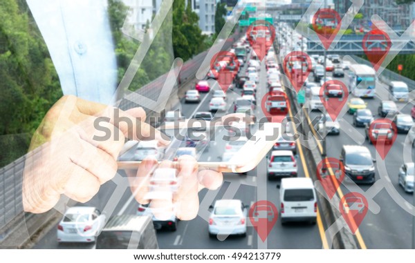 Car sharing service or rental concept. Sharing\
economy and collaborative consumption. Double exposure of business\
man holding mobile phone and use application to call car with blur\
city traffic