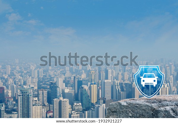 Car with shield flat icon on rock mountain over\
modern city tower, office building and skyscraper, Business\
automobile insurance\
concept