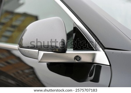 Car side mirror with integrated camera. Compact cam for parking aid and driver assistance. Car advanced side view camera system integrated into rearview mirror, blind spot detection, 360 visibility