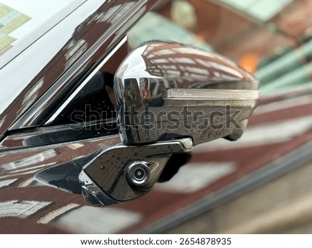 Car side mirror with integrated camera closeup, cam for driver safety and visibility. Car side view camera system integrated into rearview mirror, blind spot detection, 360 visibility. Camera 360. 