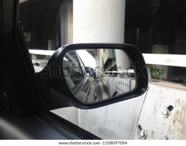 Car side mirror. Reflection of a traffic in a\
side mirror.