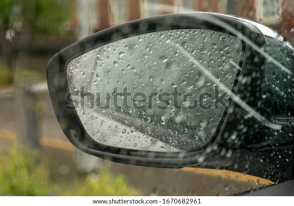 car side mirror with\
water droplets