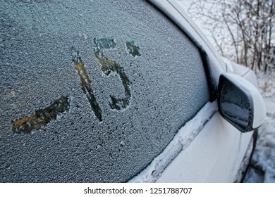 Car side window in hoarfrost. Figure on the glass. Negative temperature and frost.                       - Powered by Shutterstock