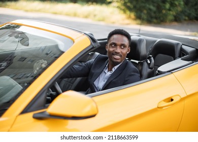 Car Side Window. Young Handsome Bearded African Businessman Driver Happy Smiling Driving Sport Yellow Car. Handsome Young Man Excited About His New Vehicle. Positive Face Expression