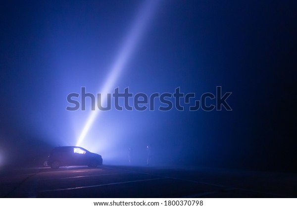 Car silhouette with\
flashlight background