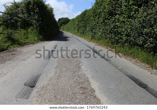 Car skid marks in a country\
lane