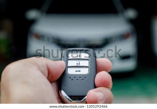 Car smart key is an electronic\
access and authorization system, Hand holding smart key of\
car.