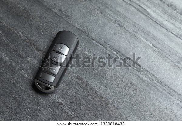 Car smart key on grey background, top view with\
space for text