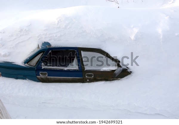Car in the snow. A passenger car was covered\
with snow. A car in a\
snowdrift.