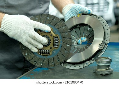 Car spare parts. The clutch kit is in the hands of an auto mechanic. Monitoring of the technical condition of the drive disc, the driven disc and the exhaust bearing. Repair and maintenance in a car s - Shutterstock ID 2101088470