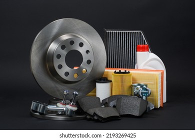 Car spare parts on a dark background. Brake discs, suspension arms and filters on a black background. - Shutterstock ID 2193269425