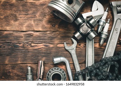 Car Spare Parts On Wooden Workbench Flat Lay Background With Copy Space.