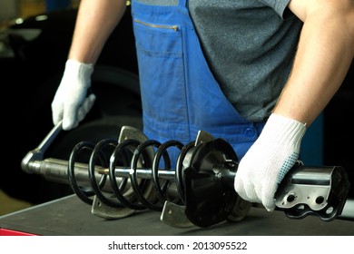 Car Spare Parts. Replacement Of The Front Spring And Shock Absorber On A Passenger Car At The Service Center. Repair And Maintenance In A Car Service Station.