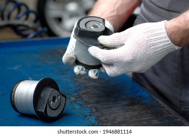 Car Spare Parts. Silent Block Of The Rear Beam, Close-up. The Car Mechanic Checks The Structural Element During The Repair Of The Car Suspension.