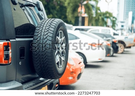 Car spare tire, spare wheel or off-road rear tire Parked in a shopping mall in Laos, Asia