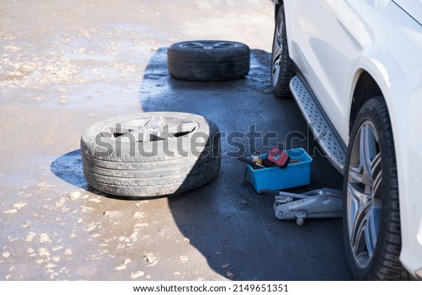 a car with\
spare wheels and tools during the\
day