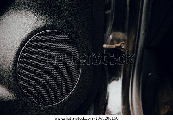 Car speaker mounted in\
the car. The concept of sound system in the car, listening to the\
radio in the car.