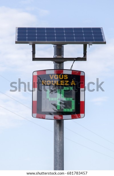 Car speed radar on the road indicating speed with a\
solar panel
