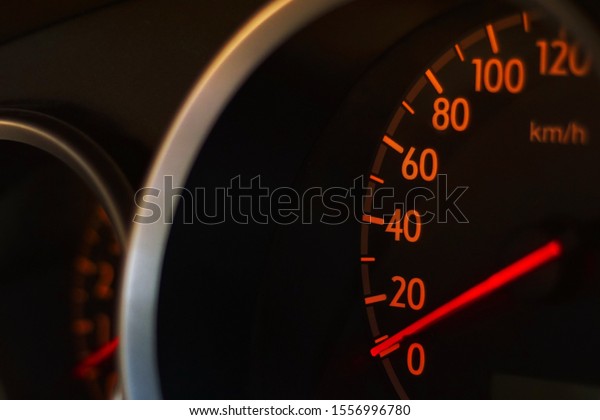 car speedometer in close up glows in the dark           \
              