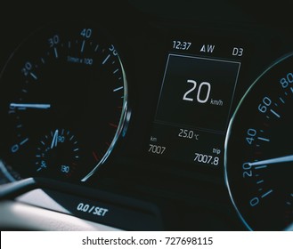 Car speedometer close-up with the needle pointing a 20 km/mph speed driving electric car digital display screen 