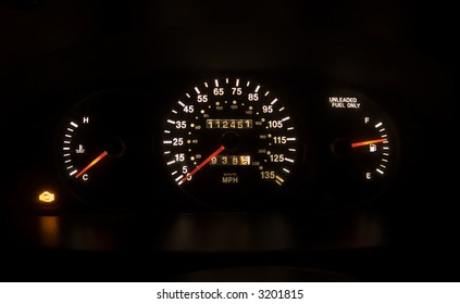 Car Speedometer Lit Up In The Dark With Check Engine Light On