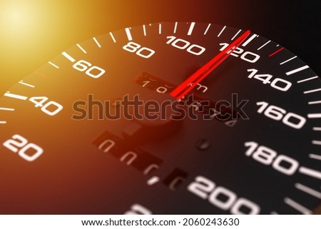 Car speedometer with the needle pointing a high speed at blackground, Speedometer with a red arrow indicating speeding, conceptual image for excessive speeding or careless driving concept.Close-up.