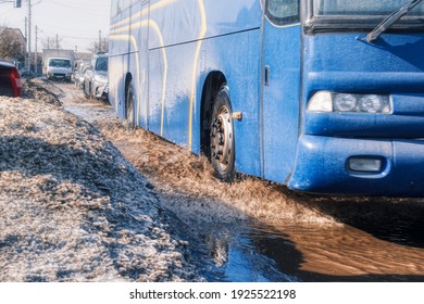 A Car Sprays Mud In A Dirt Road