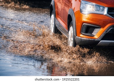 A Car Sprays Mud In A Dirt Road