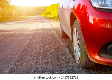 Car Standing On The Edge Of A Country Road. Evening Sun Over The Horizon. Concept Of Travel Theme. Copy Space