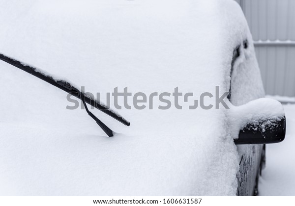Car standing in snow.\
Snowdrift of snow by car. Snow covered car. Winter, snow, car in\
snowdrift.