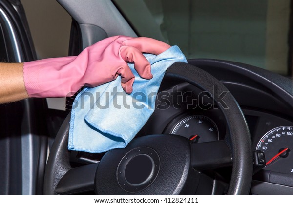 Car steering wheels\
cleaning from dust and dirt with rag. Early spring cleaning or\
regular clean up. 