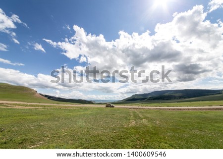The car stopped in the fields of Mongolia in Sunny weather