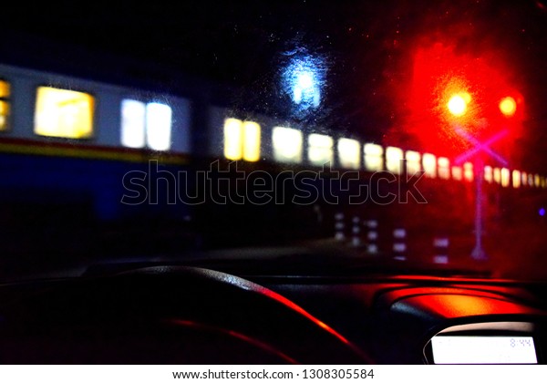 the car stopped in front of the\
railway tracks passing train (Focusing on a car\
dashboard)