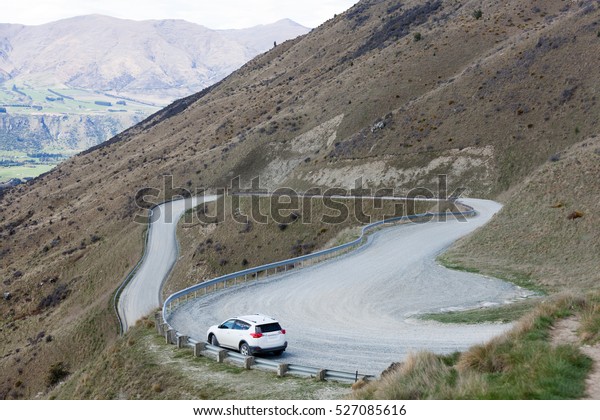 Car stopped on the side of the access road to Cardrona\
ski resort. 