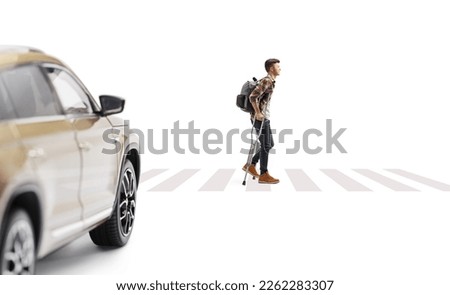 Car stopping at a pedestrian crossing and a young man walking with crutches isolated on white background