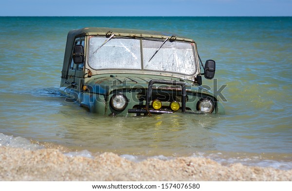 car stuck mud or submerged in sea water on beach
ocean or sea