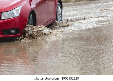 Car stuck in the mud, car wheel in a dirty puddle, rough terrain - Shutterstock ID 1903551220